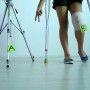Woman on crutches with bandage around knee